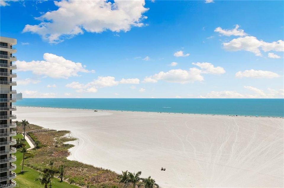 Broad white sand beach and calm turquoise Gulf water on Marco Island
